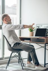 Working . A mature self-employed man working at home anf looking tired